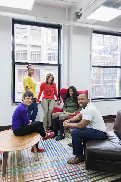 Five people from the Ableto team, four women and one man, smiling in the office lobby