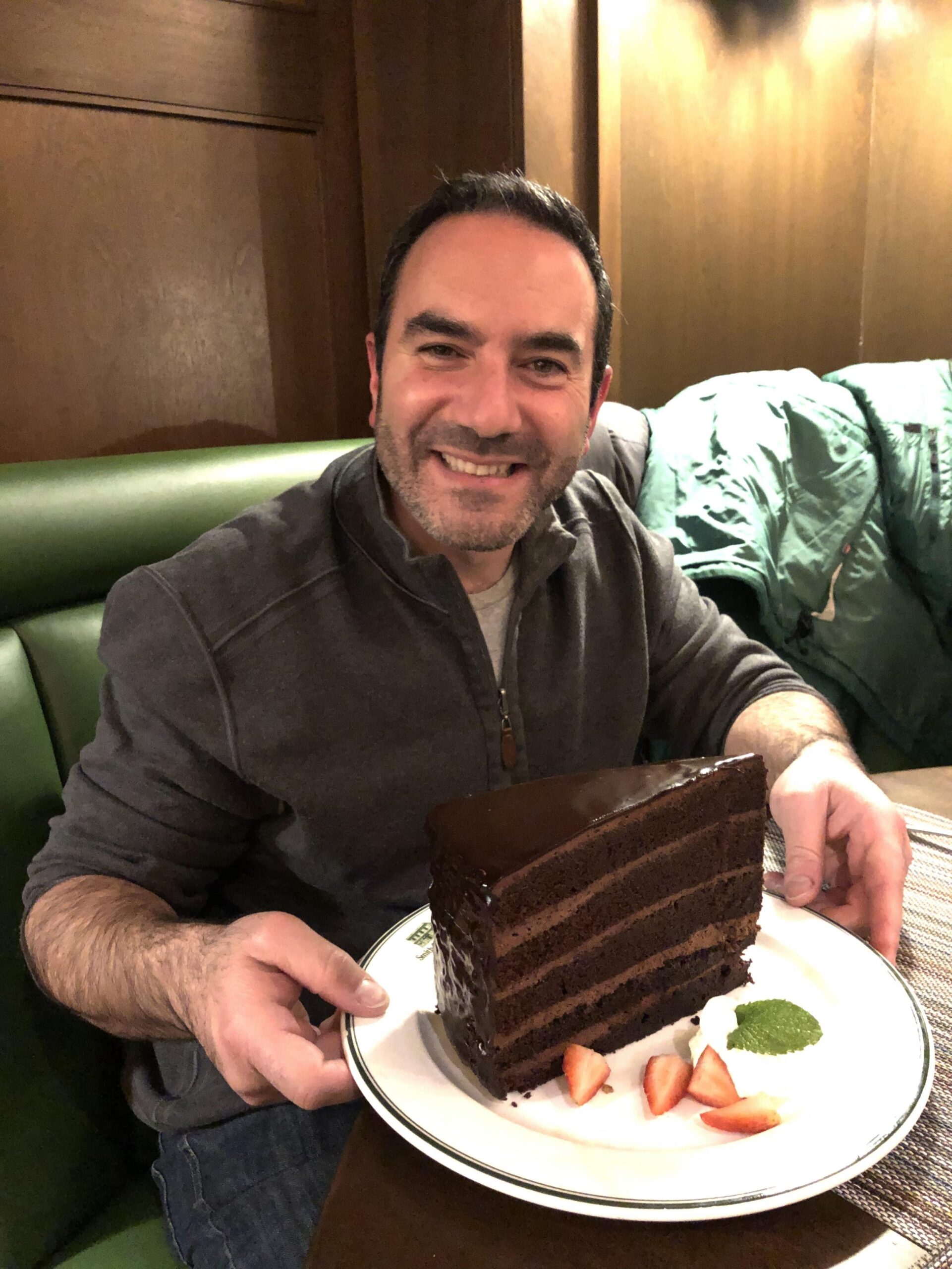 Greg Dracon with a giant piece of chocolate