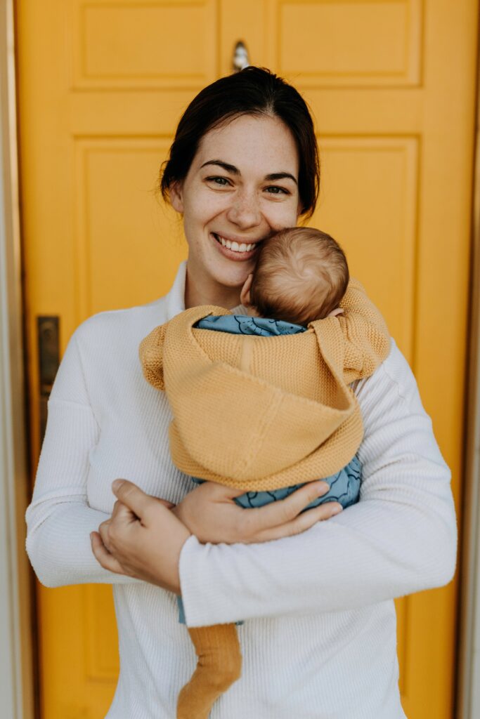 smiling young mother with child in her arms